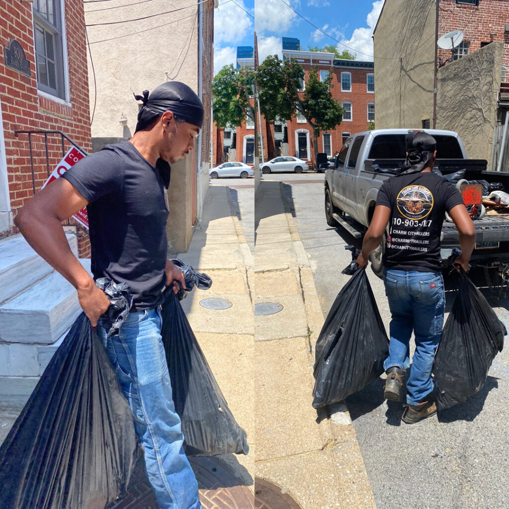 2 guys carrying trash bags-junk removal